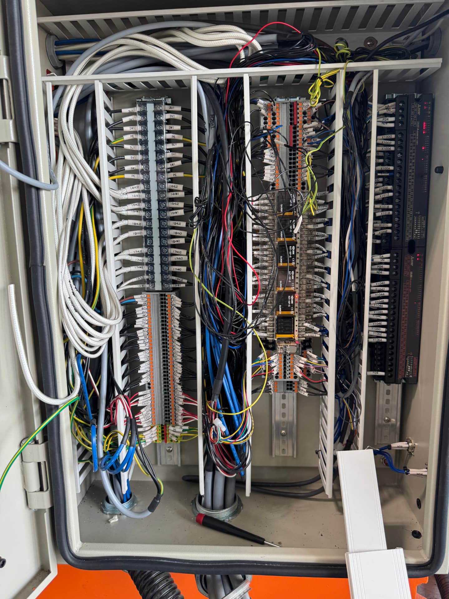 Industrial control panel after service with cleaned wiring, labeled terminals and organized control devices